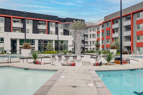 A pool area with a tree in the middle of it.
